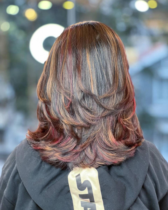 Layered Medium-Length Haircut with Cherry Red and Brown Highlights