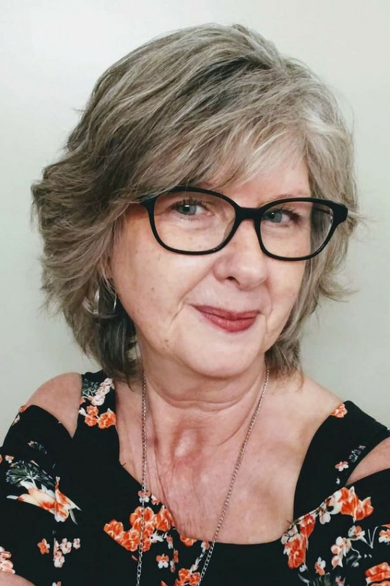 Medium-Length Layered Haircut for Women Over 60 with Glasses