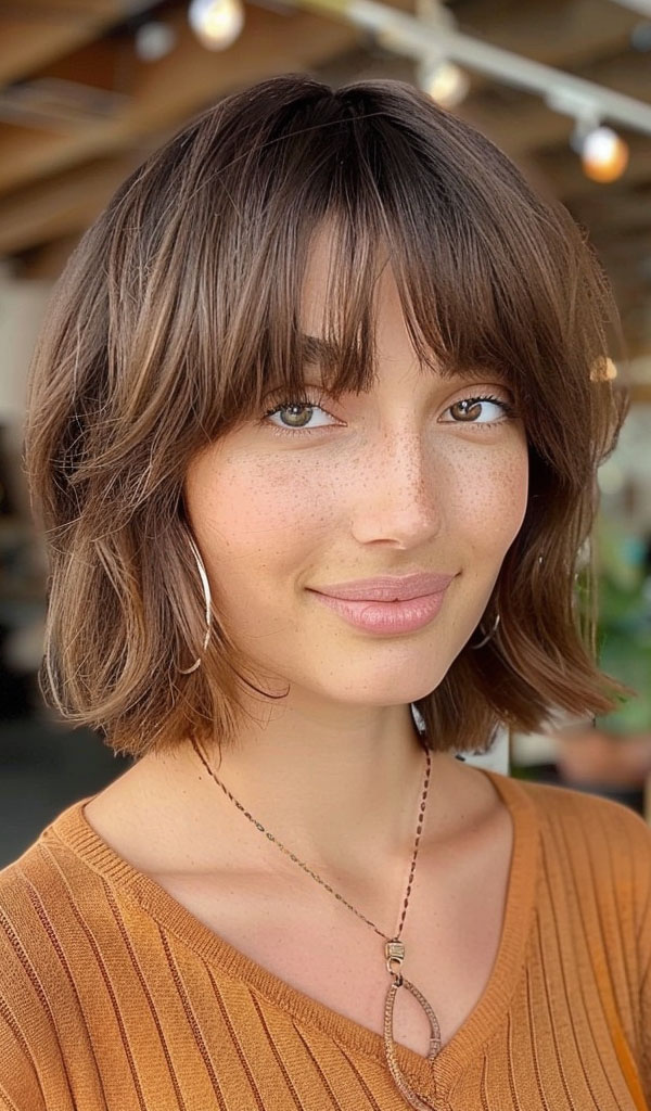 33 Chic Bob Haircuts with Bangs : Subtle Brown Wavy Bob with Wispy Bangs