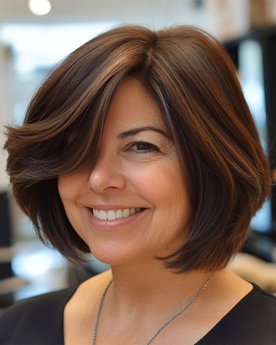 47 Bob Hairstyles for Women Over 50 : Chic Layered Bob with Side-Swept Bangs