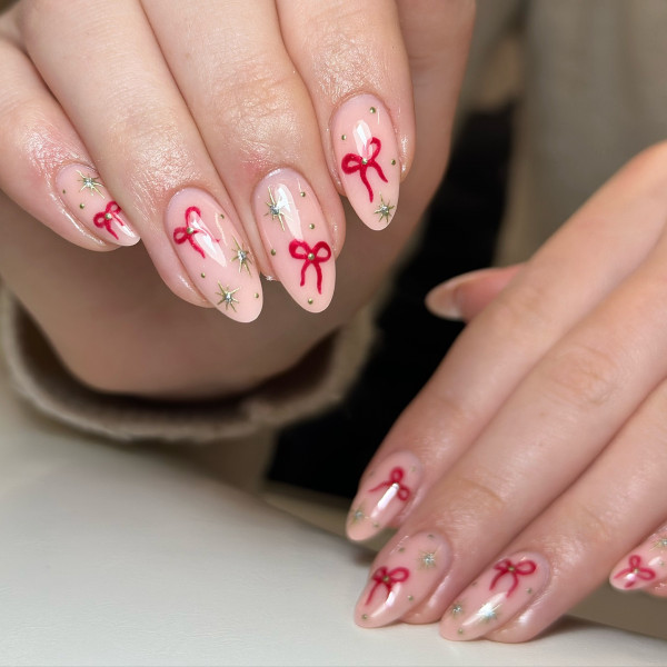 From Subtle to Sparkly Christmas Nails That Wow : Festive Bow & Sparkling Star Nails