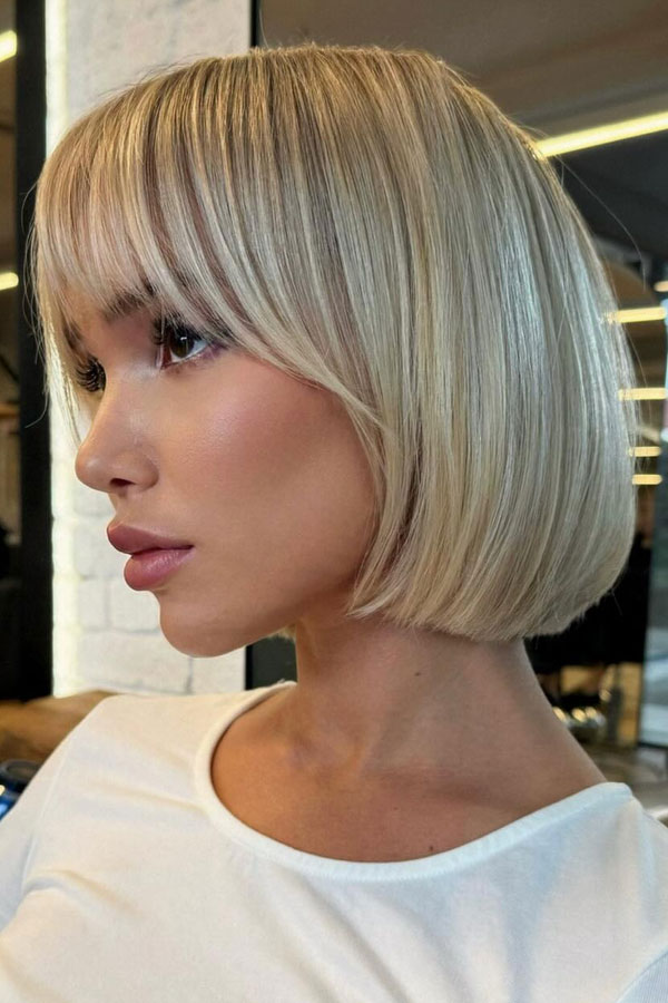 25 Chic Bob Hairstyles with Bangs to Suit Every Style : Sleek Platinum Bob with Blunt Fringe