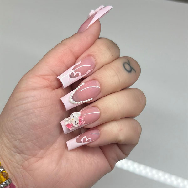 White Tip Coffin-Shaped Nails with Hello Kitty Charm, Long Coffin French Tips with Hearts, Hello Kitty nails, Hello Kitty nails acrylic, Cute Hello Kitty nails, Hello Kitty Valentine's day nails, Hello-Kitty Inspired nail art