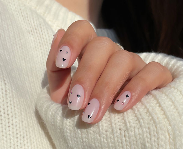 20 Minimalist Valentine’s Day Nail Designs : Nude Nails with Dainty Black Hearts