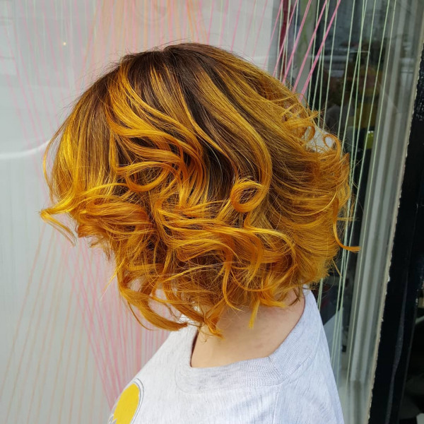 Golden Sunset Curls on a Textured Bob, Radiant Marigold Hair Colour Ideas, warm marigold hair colour, yellow hair colour, orange hair colour, warm tone hair colour