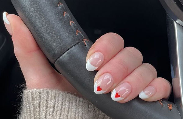 20 Minimalist Valentine’s Day Nail Designs : Classic French Tips with Red Heart Accents