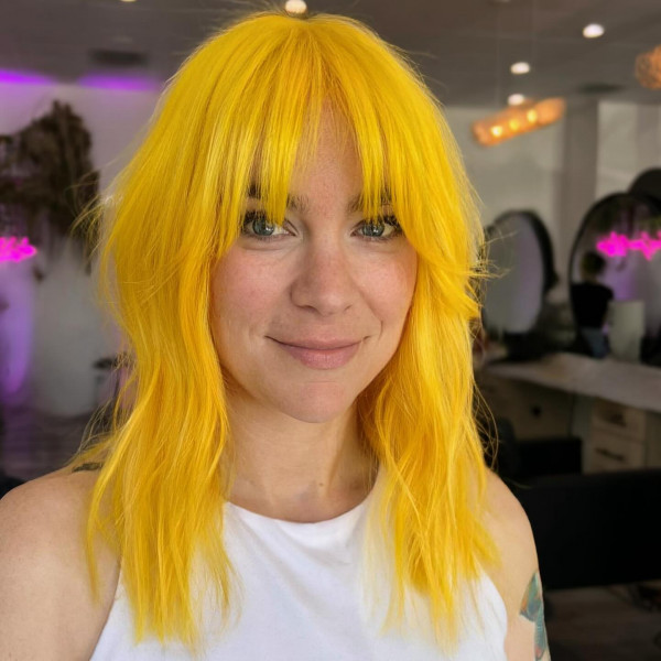 Bright Marigold Shag with Curtain Bangs, Radiant Marigold Hair Colour Ideas, warm marigold hair colour, yellow hair colour, orange hair colour, warm tone hair colour