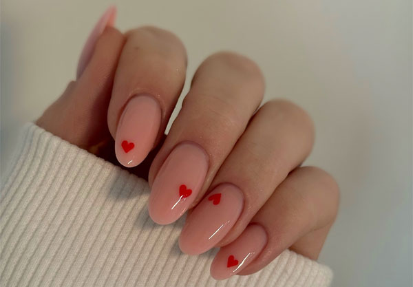 20 Minimalist Valentine’s Day Nail Designs : Glossy Nude with Bold Red Hearts