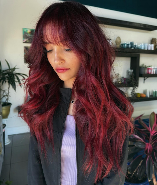 25 Rich Cherry Hair Hues for a New Look : Cherry Red Long Waves with Wispy Bangs