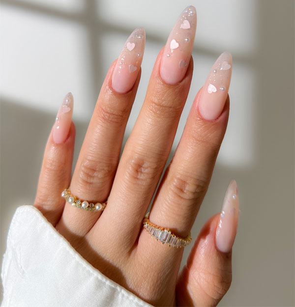 20 Minimalist Valentine’s Day Nail Designs : Glossy Nude Almond Nails with Iridescent Hearts