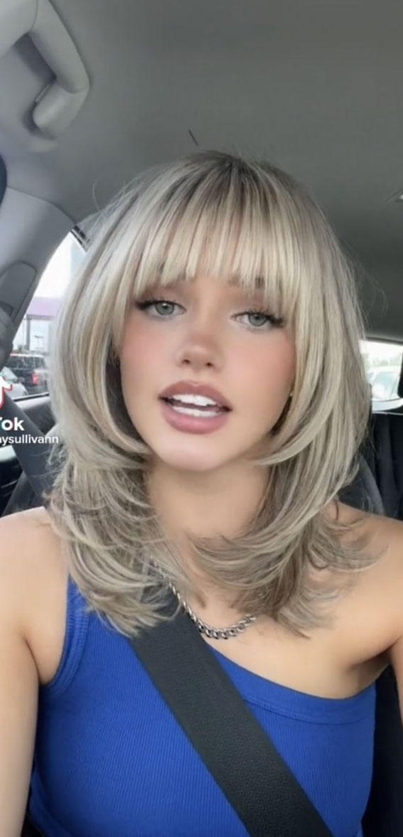 40 Best Layered Haircuts & Hairstyles For 2022 : Honey Blonde Layered Cut with Bangs