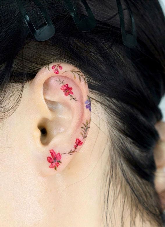 Fine line flower tattoo behind the right ear