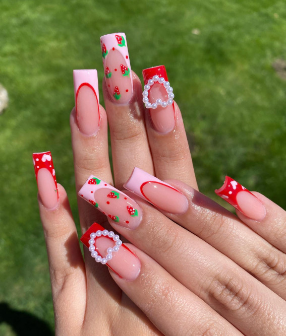 pink and red french tip nails, pink tips with strawberry accents, pink french tip nails