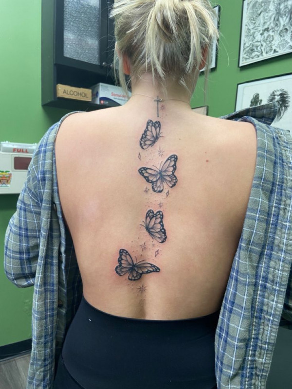 Fluttering Butterfly Spine Tattoo with Sparkle Accents