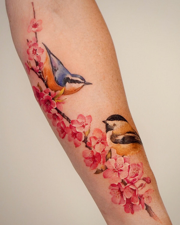 birds and cherry blossom arm tattoos, flower tattoo arm women. Flower tattoo arm female, floral arm tattoo, unique flower arm tattoos for females, colourful floral tattoos, Flower tattoo arm forearm
