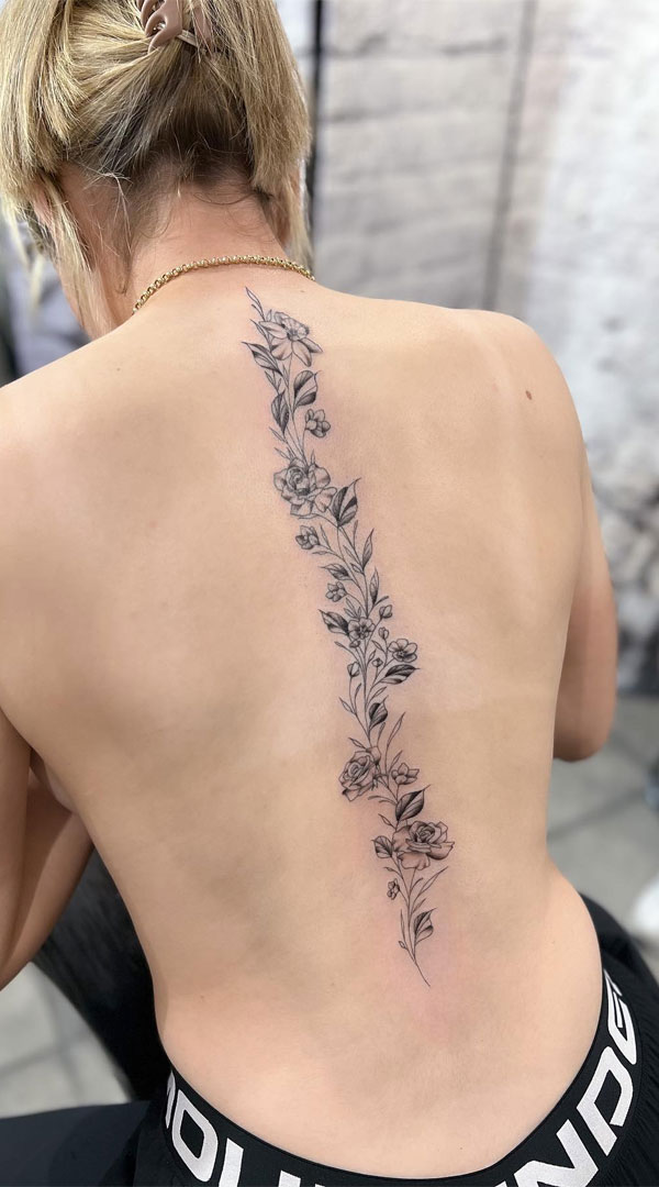 Elegant Rose Vine Spine Tattoo in Monochromatic Palette