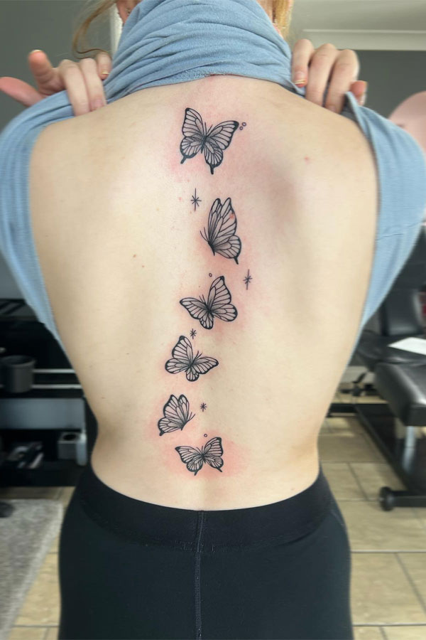 Enchanting Butterfly Spine Tattoo: Graceful Fluttering with Sparkle Accents