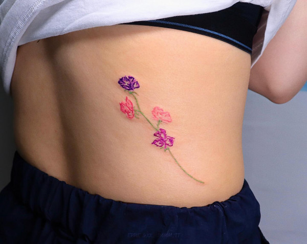 sweet pea tattoo, colourful flower back tattoos