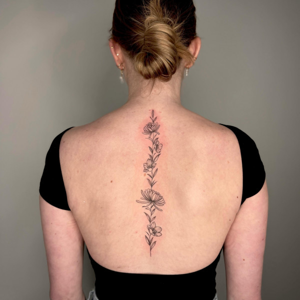 Simple black and grey flower spine tattoo