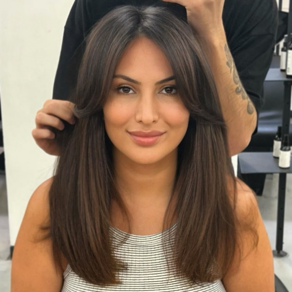 Mid-back-length straight hair with curtain bangs