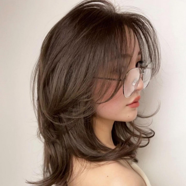 Mid-Length Layered Haircut with Wispy Curtain Bangs