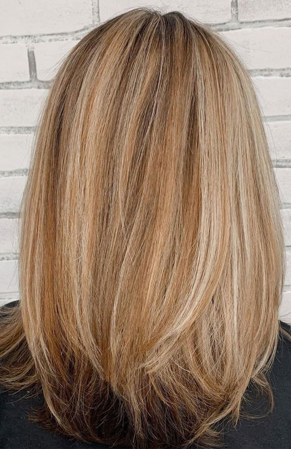 medium-length layered haircut, blonde highlights, shoulder length layers