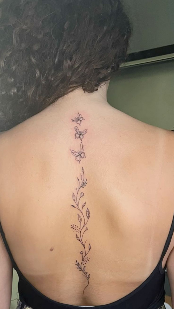 A Simple Floral Vine Tattoo with Butterfly