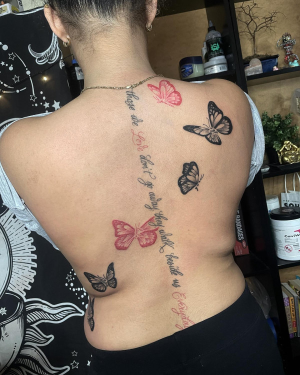script spine tattoo with butterflies, red and black butterfly tattoo, script spine tattoo, spine tattoo with script