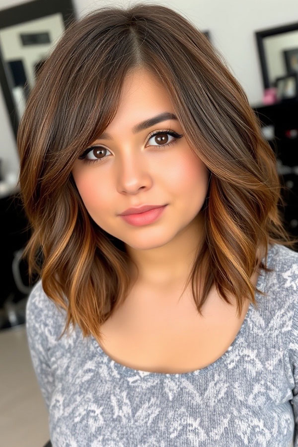 Layered Bob with Side Bangs and Warm Highlights