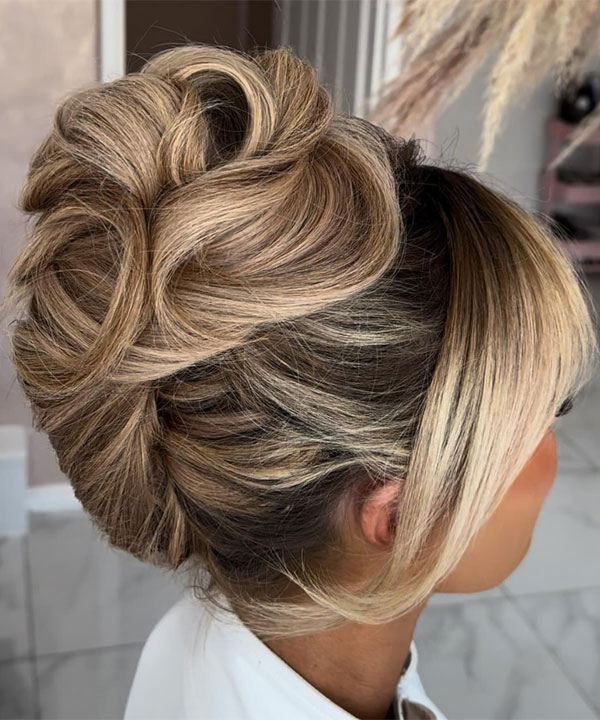 Sculpted Blonde Updo with Curtain Bangs, 90s inspired updo, Pamera Anderson inspired updo, piled updos, trending piled updo hairstyle, trendsetting updo hairstyle