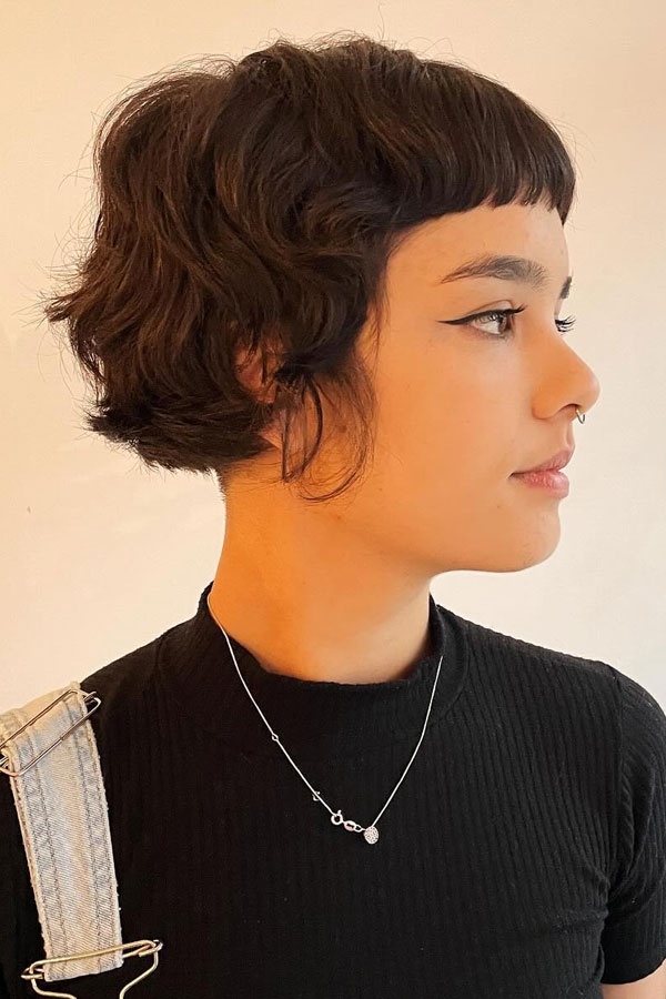 27 French Hairstyles for a Chic Makeover: Curly Mini French Bob with Micro Bangs