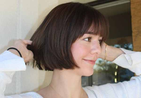 27 French Hairstyles for a Chic Makeover: Rich Mocha Brown Rounded Bob with Feathered Bangs