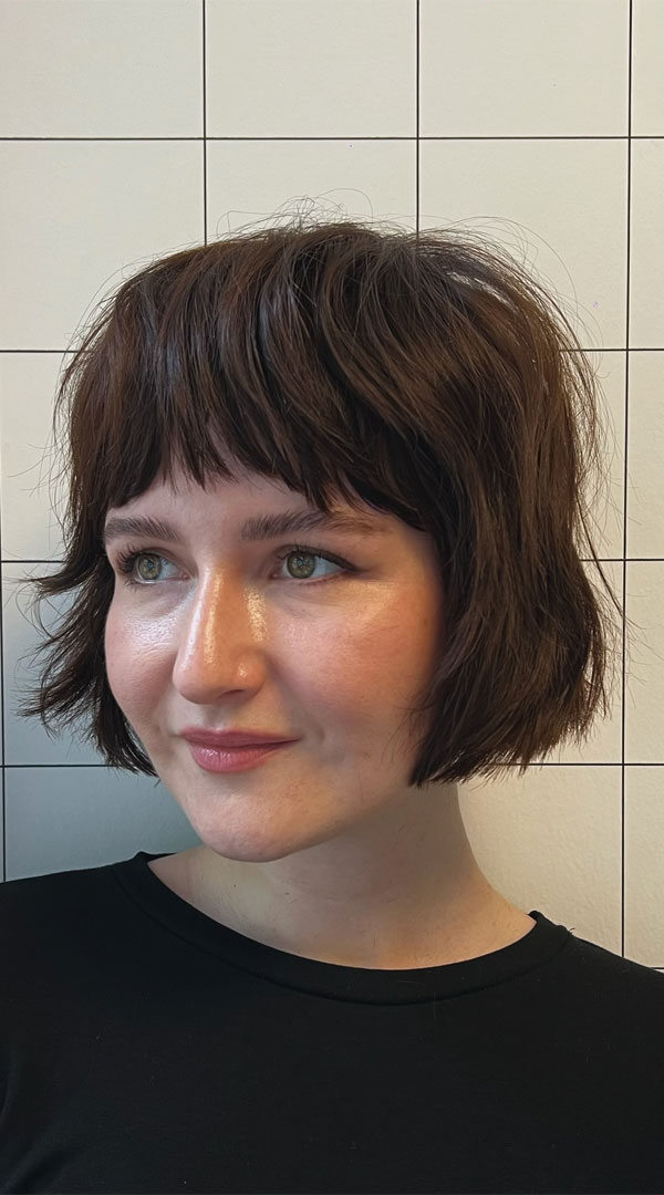 27 French Hairstyles for a Chic Makeover: Textured Shaggy Bob with Wispy Bangs