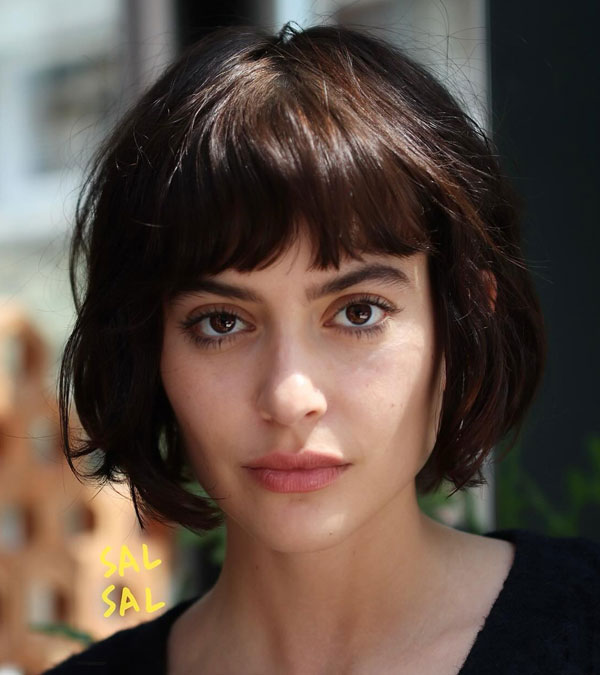 27 French Hairstyles for a Chic Makeover: Tousled French Bob with Feathered Bangs